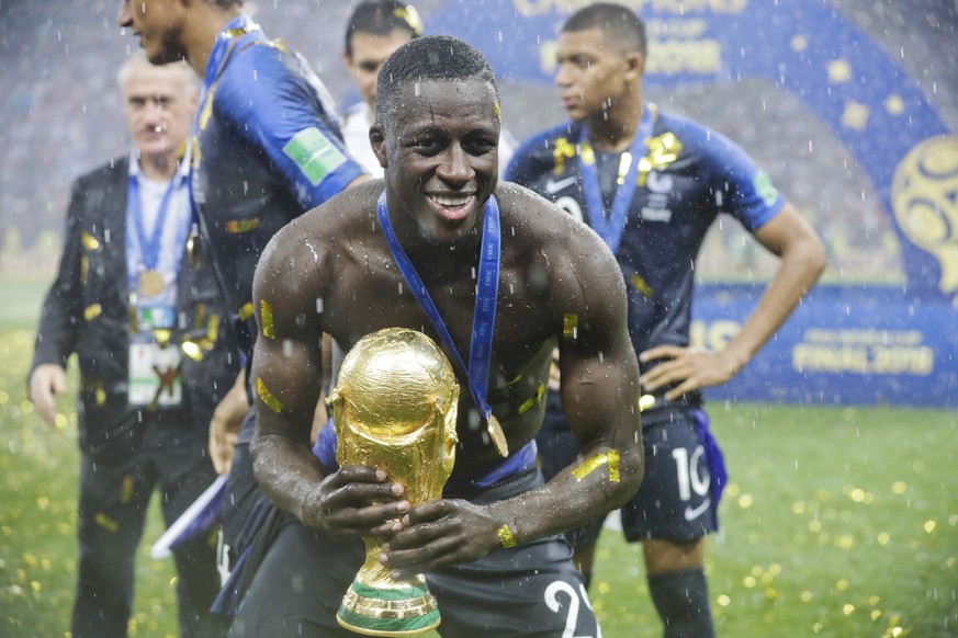 France's Benjamin Mendy holds the trophy at the end of the final match between France and Croatia at the 2018 soccer World Cup in the Luzhniki Stadium in Moscow, Russia, Sunday, July 15, 2018. (A ...