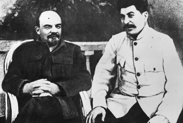 FILE - Soviet founder Vladimir Lenin, left, and Soviet leader Josef Stalin sit in a park at Gorki residence in 1922 just outside Moscow, Russia. With its brutality, technological accomplishments and r ...