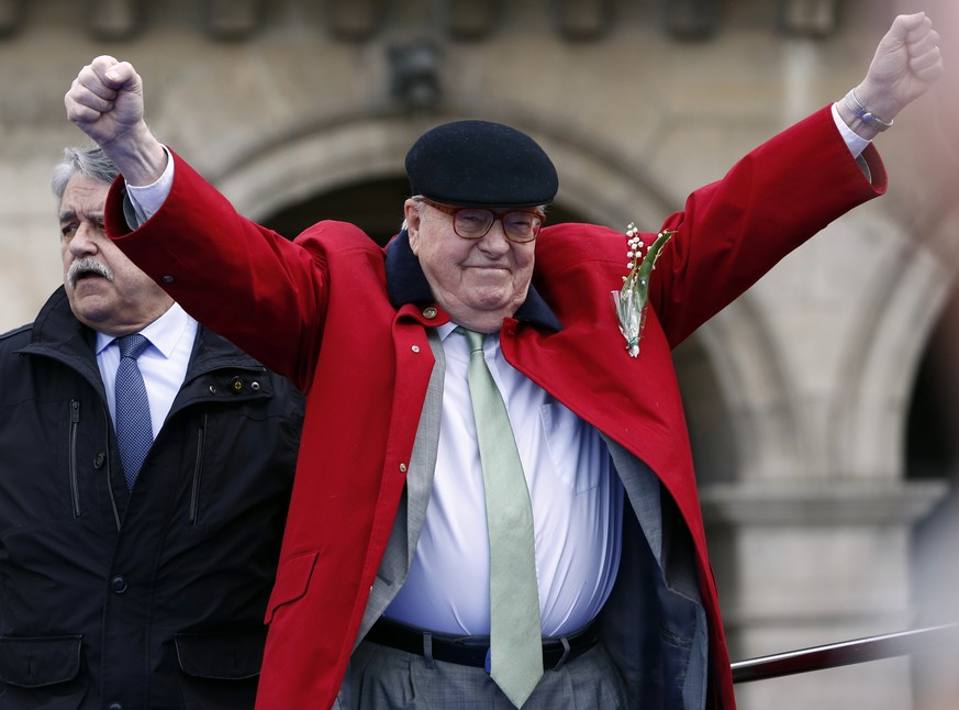 FILE - In this May 1, 2017 file photo, former far-right National Front party leader Jean-Marie Le Pen reacts the statue of Joan of Arc, in Paris. French far-right leader Marine Le Pen is coming under  ...