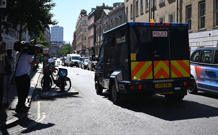 epa10115436 Media members watch a van carryign British terror suspect Aine Davis as he is transported from Westminster Magistrates Court in London, Britain, 11 August 2022. British national Aine Davis ...