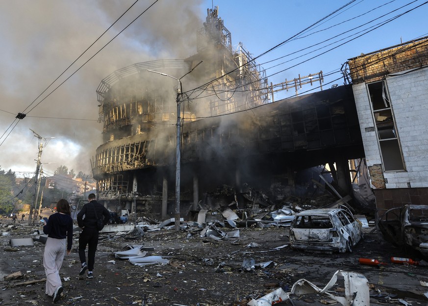 epa12989716 Local residents walk among debris at the site of a Russian strike on a shopping center in Kyiv, Ukraine, 24 May 2026, amid the Russian invasion. More than 600 drones and 90 missiles struck ...