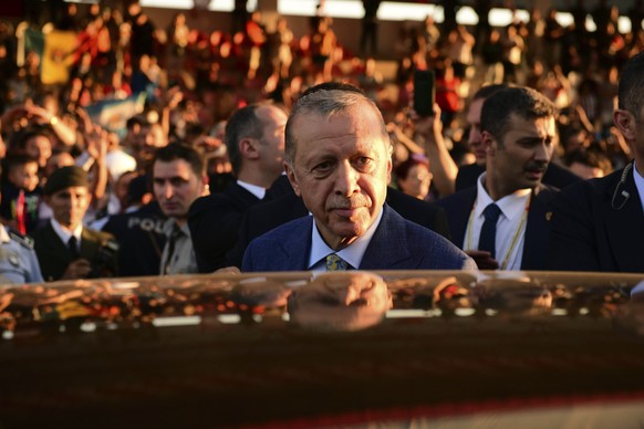 Turkish President Recep Tayyip Erdogan gets into a car after attending a military parade marking the 49th anniversary of Turkish invasion, in the Turkish occupied area of the divided capital Nicosia,  ...