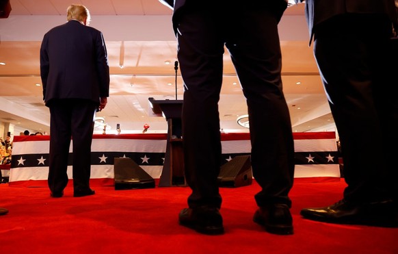 NASHUA, NEW HAMPSHIRE - JANUARY 23: Republican presidential candidate and former U.S. President Donald Trump stands on stage during his primary night rally at the Sheraton on January 23, 2024 in Nashu ...