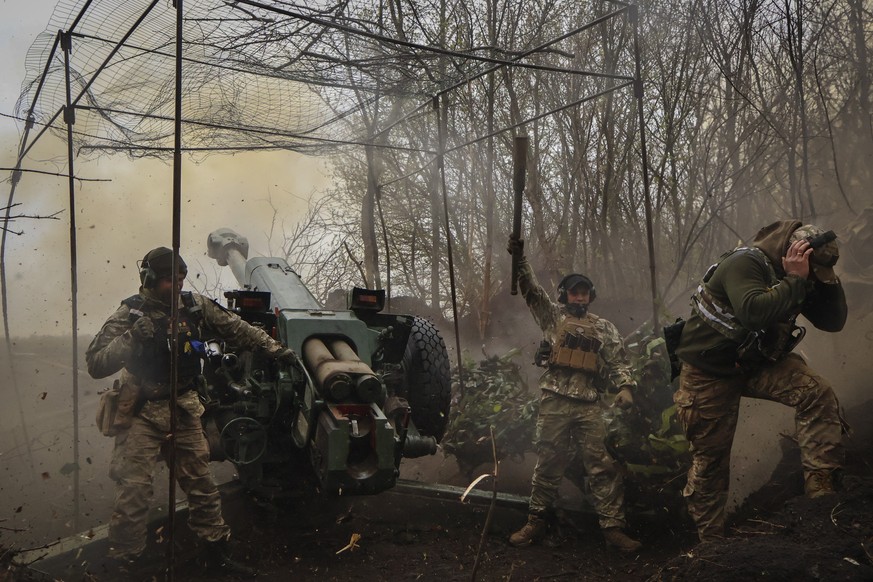 Ukrainian soldiers fire howitzer D-30 at the frontline near Bakhmut, Donetsk region, Ukraine, Wednesday, Apr. 19, 2023. (Roman Chop via AP)