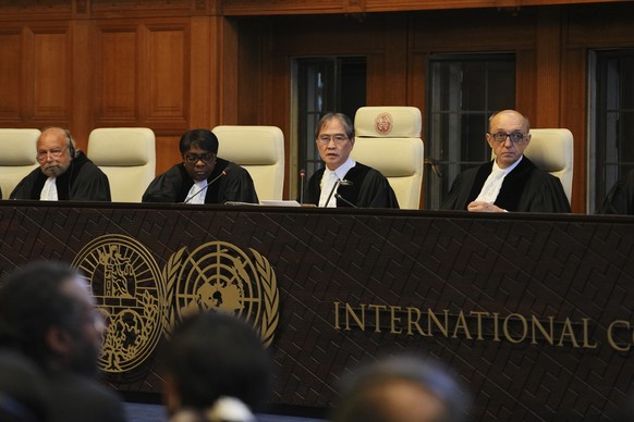 Presiding judge Yuji Iwasawa, second from right, speaks at a hearing to deliver an advisory opinion on what legal obligations nations have to address climate change and what consequences they may face ...