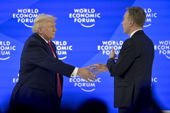 US President Donald Trump, left, shakes hands with Norwegian Borge Brende President and CEO of the World Economic Forum, right, at the 56th annual meeting of the World Economic Forum, WEF, in Davos, S ...
