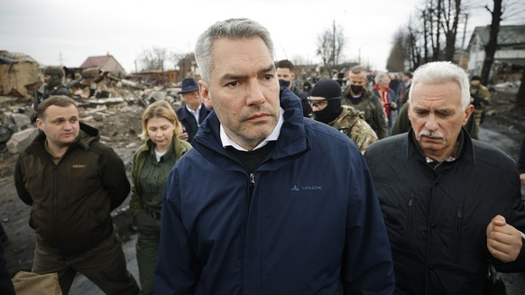 epa09880782 A handout photo made available by the Austrian Chancellery shows Austrian Chancellor Karl Nehammer (C) during a visit to Bucha, near Kyiv, Ukraine, 09 April 2022. Nehammer is on a one-day  ...