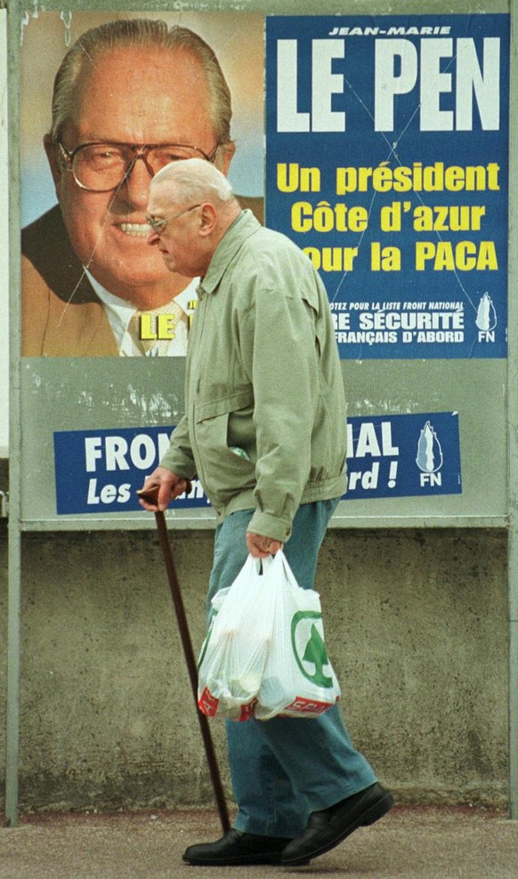 An old man walks past an election poster for the far right national front leader Jean-Marie Le Pen, Wednesday March 11, 1998, in Nice on the French riviera. Le Pen is running in Sunday&#039;s regional ...