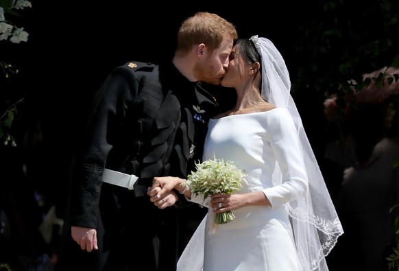 Prince Harry and Meghan Markle kiss outside St George&#039;s Chapel in Windsor Castle after their wedding. (Photo by Jane Barlow/PA Images via Getty Images)