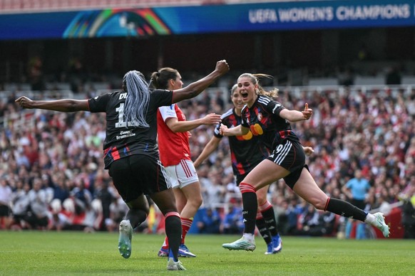 Lyon's German striker #29 Jule Brand (R) celebrates after scoring her team's first goal during the women's UEFA Champions League first-leg semi-final football match between Arsenal and  ...