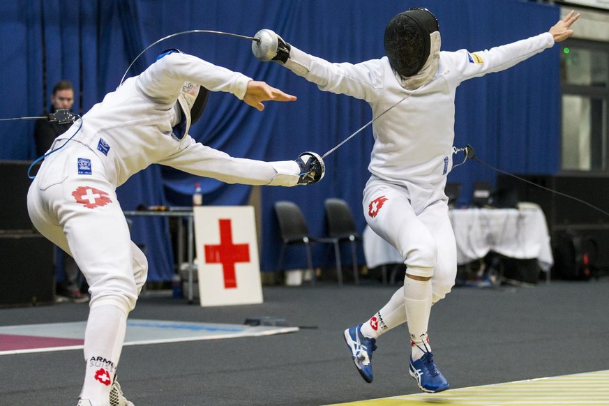 Benjamin Steffen of Switzerland, left, fights against Lucas Malcotti of Switzerland, right, during round of 32 at the Grand Prix Bern epee fencing world cup tournament in Bern, Switzerland, Saturday,  ...