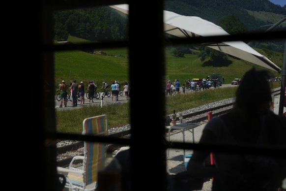 Spectators watch the breakaway group of riders pass during the ninth stage of the Tour de France cycling race over 193 kilometers (119.9 miles) with start in Aigle, Switzerland and finish in Chatel le ...