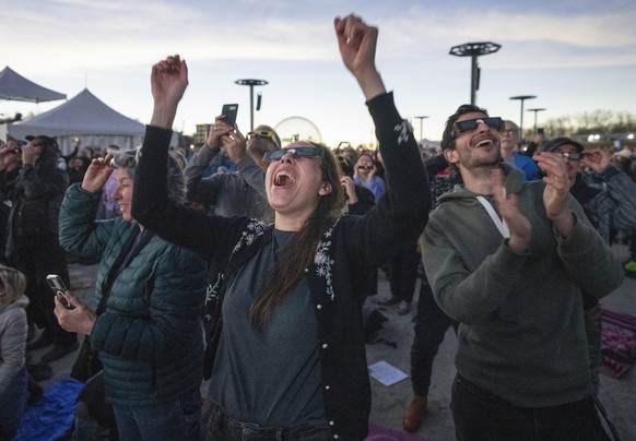 People react to totality occurring during the total solar eclipse at Parc Jean Drapeau, in Montreal, Monday, April 8, 2024. (Ryan Remiorz/The Canadian Press via AP)
