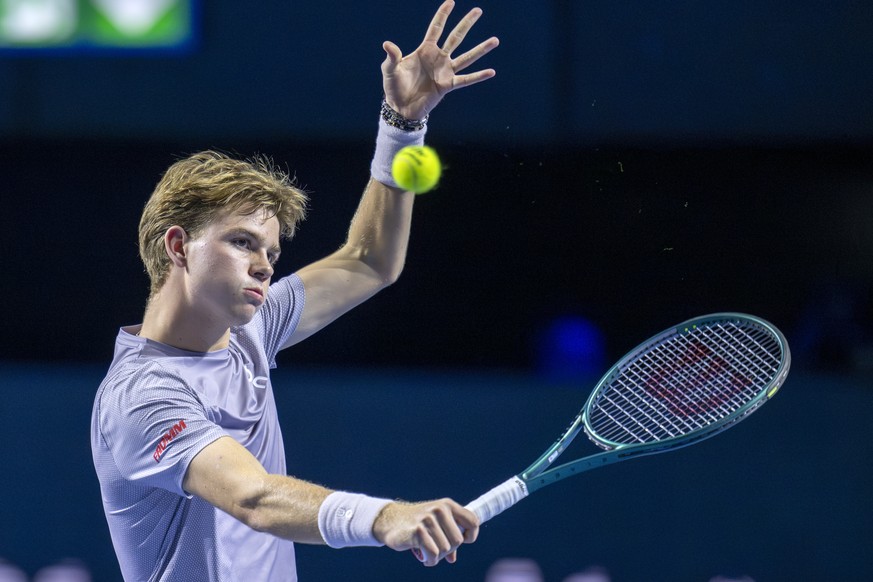 Switzerland's Henry Bernet returns a ball to Czech Republic's Jakub Mensik during their first round match at the Swiss Indoors tennis tournament at the St. Jakobshalle in Basel, Switzerland, ...