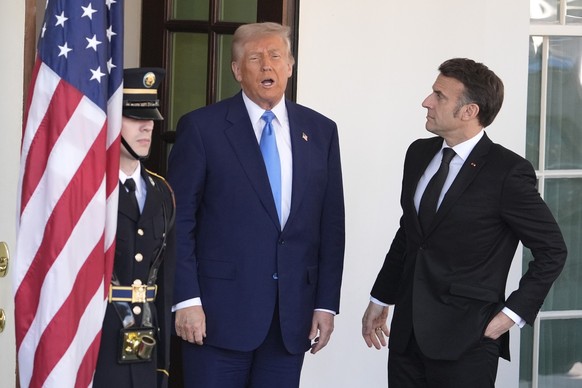 President Donald Trump, left, speaks as he greets France's President Emmanuel Macron before a news conference at the White House, Monday, Feb. 24, 2025, in Washington. (AP Photo/Manuel Balce Cene ...