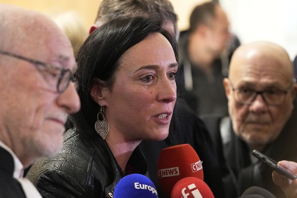 Alain Jakubowicz, left, a lawyer for the &quot;AF447 Help and Solidarity&quot; association, and Ophelie Touillou, a sister of a victim, answer reporters after the verdict outside the courtroom, Monday ...