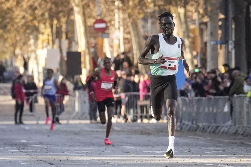 epa11051012 Sudanese runner Dominic Lobalu is in action to win the 5 kilometers on the road Cursa dels Nassos men&#039;s race in Barcelona city, Catalonia region, north-eastern Spain, 31 December 2023 ...