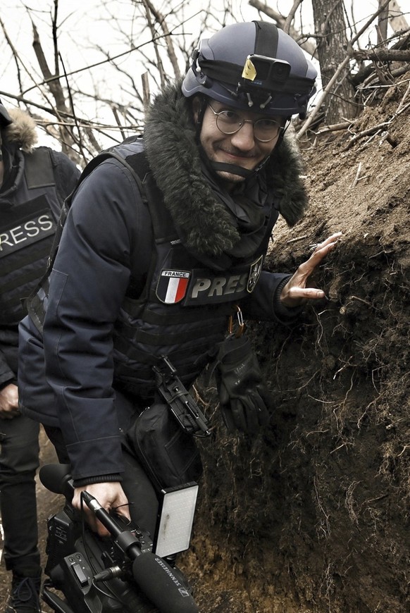 AFP journalist Arman Soldin walks in a trench as he is covers the war in Ukraine, March 18, 2023. French international news agency Agence France-Presse says its Ukraine video coordinator Arman Soldin  ...