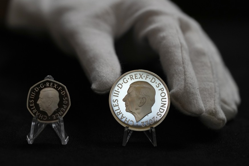 Two new coins bearing official coinage portrait of King Charles III, on the left is the new 50 pence coin, and right is the new 5 pound commemorative coin, which will be among the first coins to bear  ...
