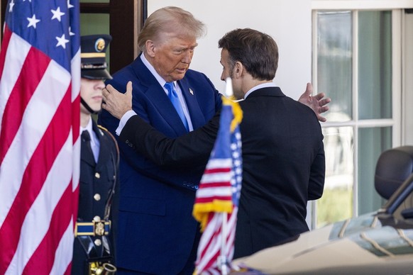 epa11921983 US President Donald J. Trump (L) greets French President Emmanuel Macron (R) as he arrives at the White House in Washington, DC, USA, 24 February 2025. EPA/SHAWN THEW