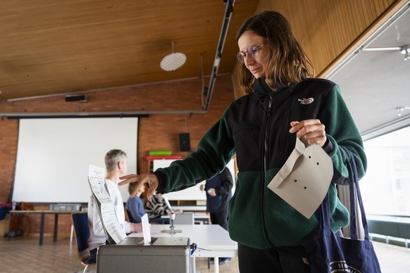 Eine Stimmbuergerin wirft ihren Stimmzettel in die Urne, im Stimmlokal Schulhaus Hochfeld, am Samstag, 2. Maerz 2024 in Bern. Die Schweizer Buergerinnen und Buerger stimmen ueber die Renteninitiative  ...