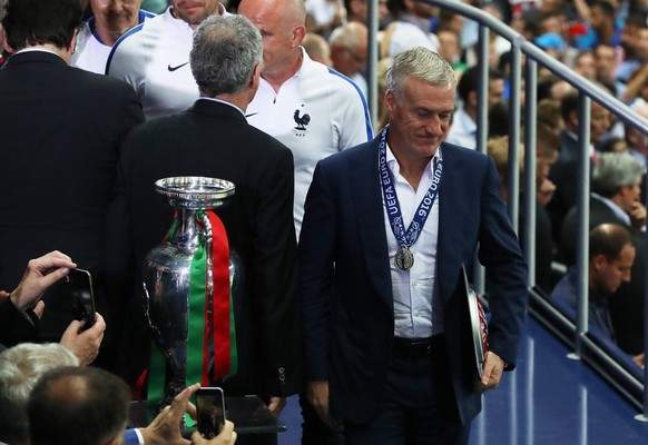 epa05419777 French coach Didier Deschamps walks past the trophy after the UEFA EURO 2016 Final match between Portugal and France at Stade de France in Saint-Denis, France, 10 July 2016.......(RESTRICT ...