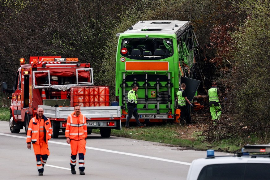 epa11247026 Emergency personnel work at the scene of a bus accident on the A9 highway in Schkeuditz, near Leipzig, Germany, 27 March 2024. At least five people died and several others were injured aft ...