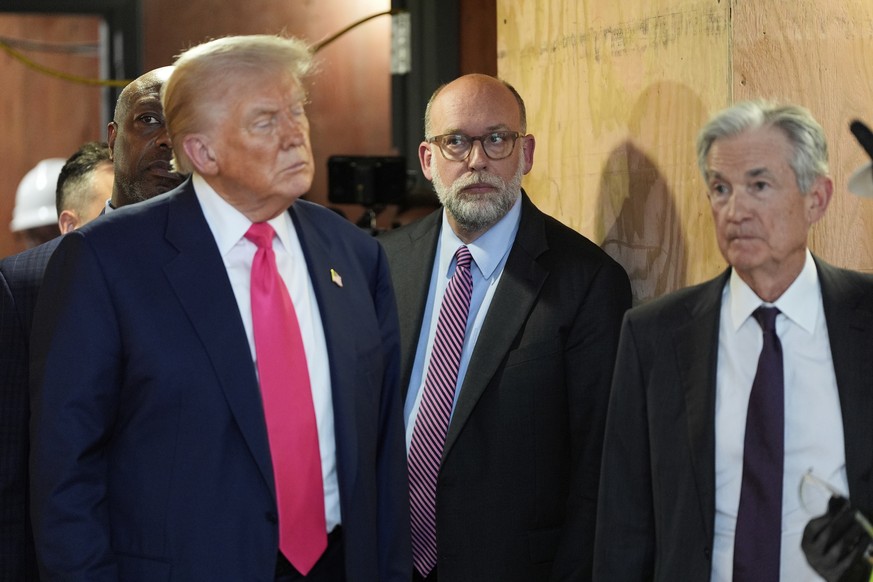 Russell Vought, director of the Office of Management and Budget, center, with President Donald Trump, left and Federal Reserve Chairman Jerome Powell, visit the Federal Reserve, Thursday, July 24, 202 ...