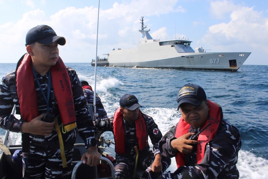 In this photo released by Makassar Search and Rescue Office on Sunday, July 19, 2026, Indonesian Navy personnel cruises on a rubber boat during a search for victims after a passenger boat sank in the  ...