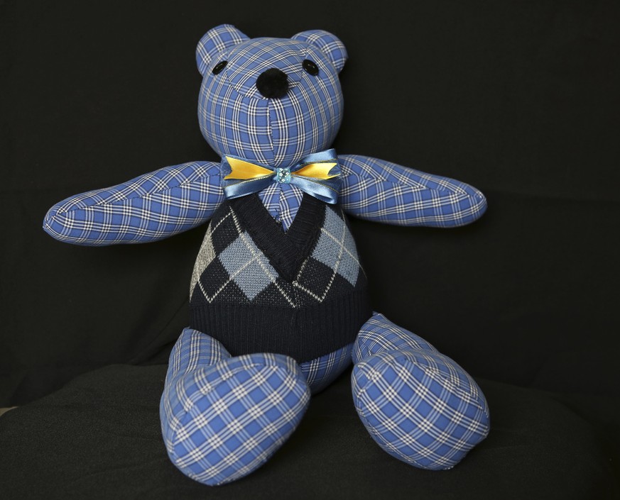 A teddy bear made with pieces of clothing that were worn by a COVID-19 victim, sits in the workshop of seamstress Irma de la Parra, in Mexico City, Saturday, April 24, 2021. De la Parra used to make t ...