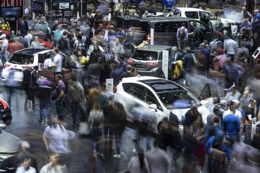 Peoples looking at Toyota cars during they visit to the 89th Geneva International Motor Show, in Geneva, Switzerland, Saturday, March 16, 2019. The Motor Show open its gates to the public from 7 to 17 ...