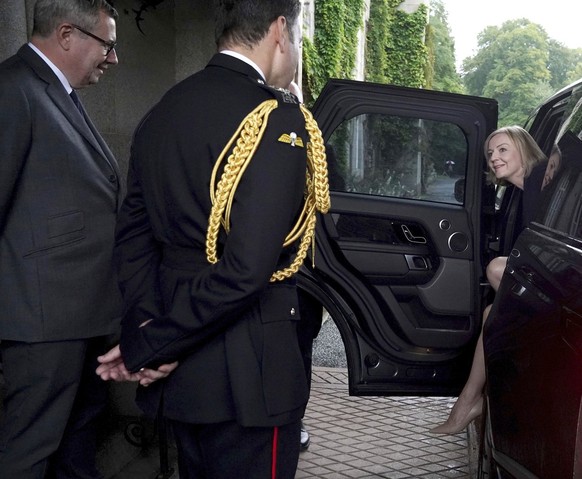 Newly elected leader of the Conservative party Liz Truss is greeted by Queen Elizabeth II&#039;s Equerry Lieutenant Colonel Tom White and her Private Secretary Sir Edward Young as she arrives at Balmo ...