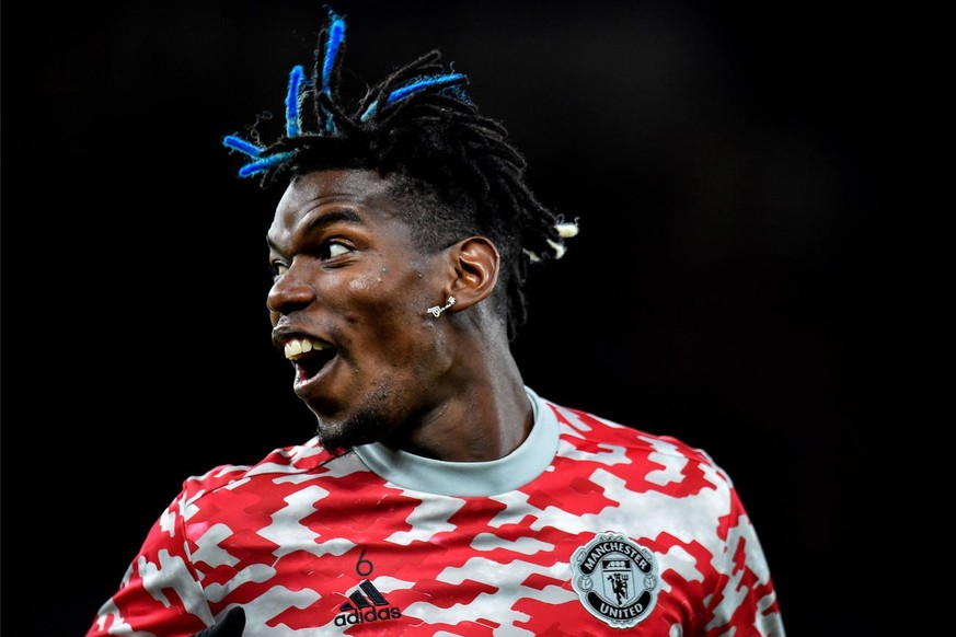 epa09534822 Manchester United&#039;s Paul Pogba reacts as he warms up prior to the UEFA Champions League group F soccer match between Manchester United and Atalanta BC in Manchester, Britain, 20 Octob ...