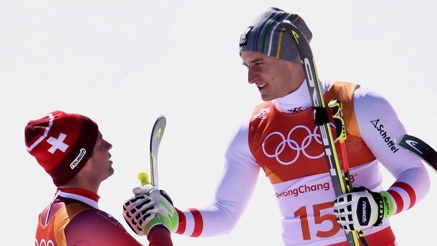 epa06531027 (L-R) silver medal winner Beat Feuz of Switzerland, gold medal winner Matthias Mayer of Austria, bronze medal winner Kjetil Jansrud of Norway during the venue ceremony of the Men&#039;s Su ...