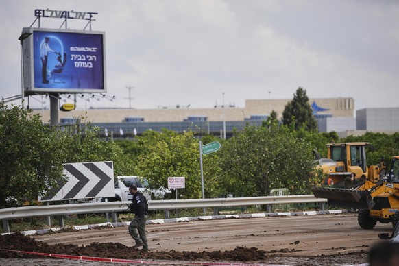 Israeli security forces inspect the site where the Israeli military said a projectile fired by Yemen&#039;s Houthi rebels landed in the area of Ben Gurion International Airport near Tel Aviv, Israel,  ...