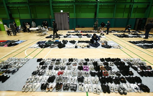 Police check shoes and clothes collected from the scene of an stampede, at a multi-purpose gym in Seoul, South Korea, 01 November 2022. According to the National Fire Agency, at least 154 people were  ...