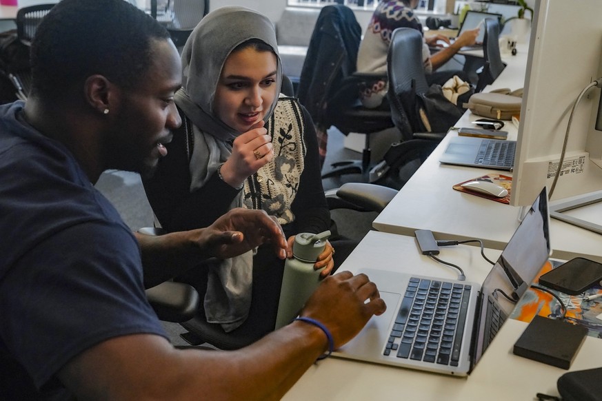 Calvin Milliner, left, and Reem Farhat, reporters for The News Movement (TNM), a social media news operation re-imagined for Gen-Z consumers, review video Thursday, March 2, 2023, in New York. TNM use ...