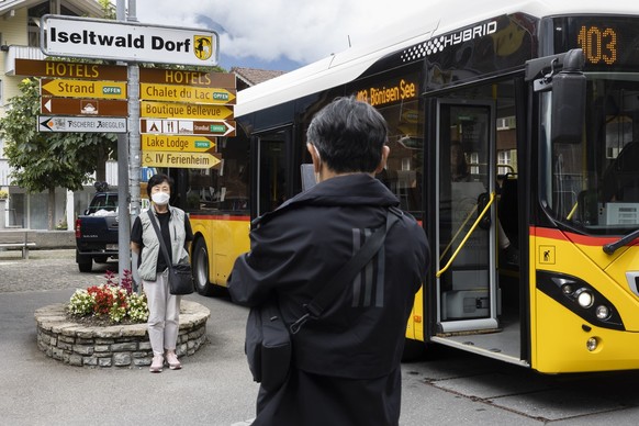 Korean visitors take pictures at the bus stop Iseltwald Dorf, Tuesday, July 26, 2022 in Iseltwalt at the lake Brienzersee. Lots of Asian TV fans and tourists visit the place because the romantic Korea ...