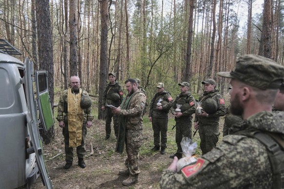 In this photo taken from video distributed by Russian Defense Ministry Press Service on Sunday, April 20, 2025, Russian soldiers attend a religion service on eve of Orthodox Easter at an unspecified l ...