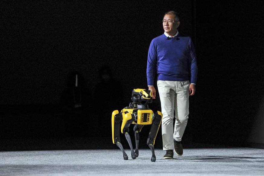 Euisun Chung, Chairman of Hyundai Motor Group, takes the stage with the robot Spot from Boston Dynamics during the Hyundai news conference at the CES tech show Tuesday, Jan. 4, 2022, in Las Vegas. (AP ...