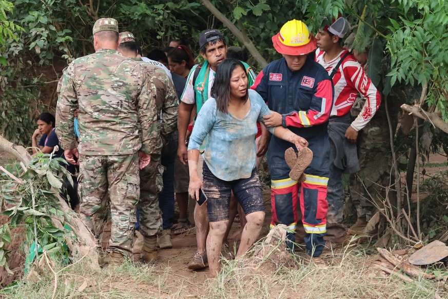 epa12590831 A person is rescued in an area affected by a river overflowing, in El Torno, Bolivia, 13 December 2025. Flooded communities, injured people, evacuees, and at least two destroyed bridges ar ...