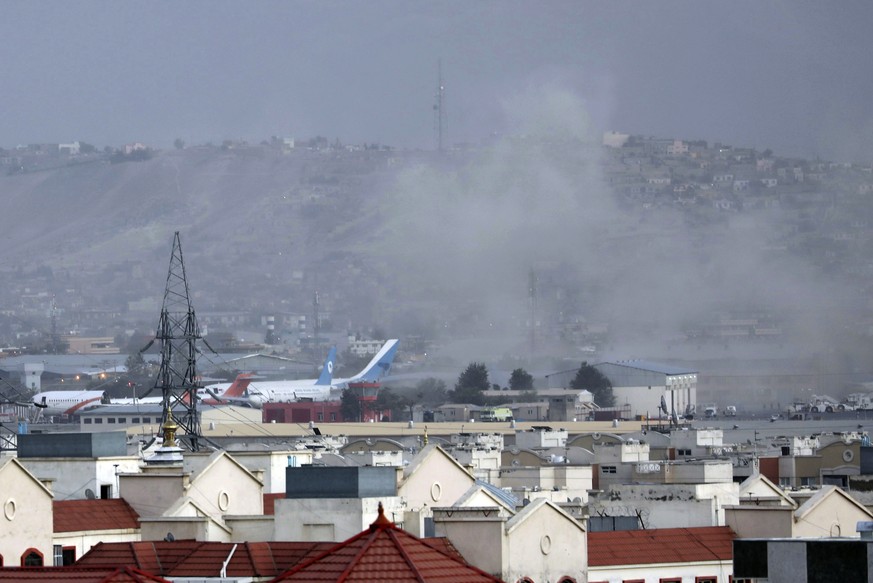 Smoke rises from a deadly explosion outside the airport in Kabul, Afghanistan, Thursday, Aug. 26, 2021. Two suicide bombers and gunmen have targeted crowds massing near the Kabul airport, in the wanin ...