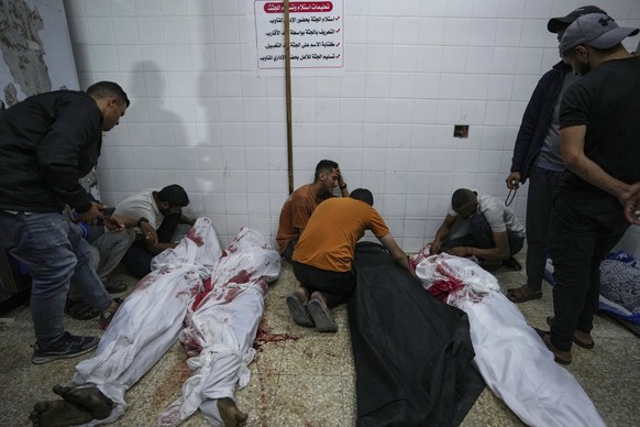 Palestinians react next to the bodies of their relatives who were killed in an Israeli airstrike in Gaza Stirp, at the Al Aqsa hospital in Deir al Balah, Gaza, Sunday, May 5, 2024. (AP Photo/Abdel Kar ...