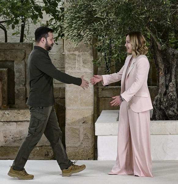 epa11407705 Italy's Prime Minister Giorgia Meloni (R) greets Ukrainian President Volodymyr Zelensky (L) during a welcome ceremony for the G7 summit in Borgo Egnazia, southern Italy, 13 June 2024. ...