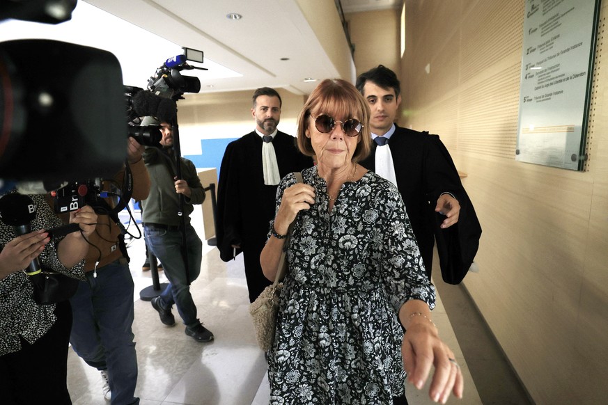 epa11609181 Gisele Pelicot (2-R), escorted by her lawyers Stephane Babonneau (R) and Antoine Camus (C), exits the criminal court following a hearing during her former husband&#039;s rape trial, in Avi ...