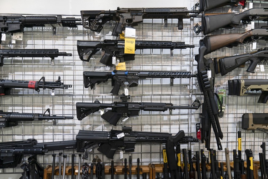 FILE - AR-15-style rifles are on display at Burbank Ammo &amp; Guns in Burbank, Calif., June 23, 2022. Gun manufacturers have made more than $1 billion from selling AR-15-style guns over the past deca ...