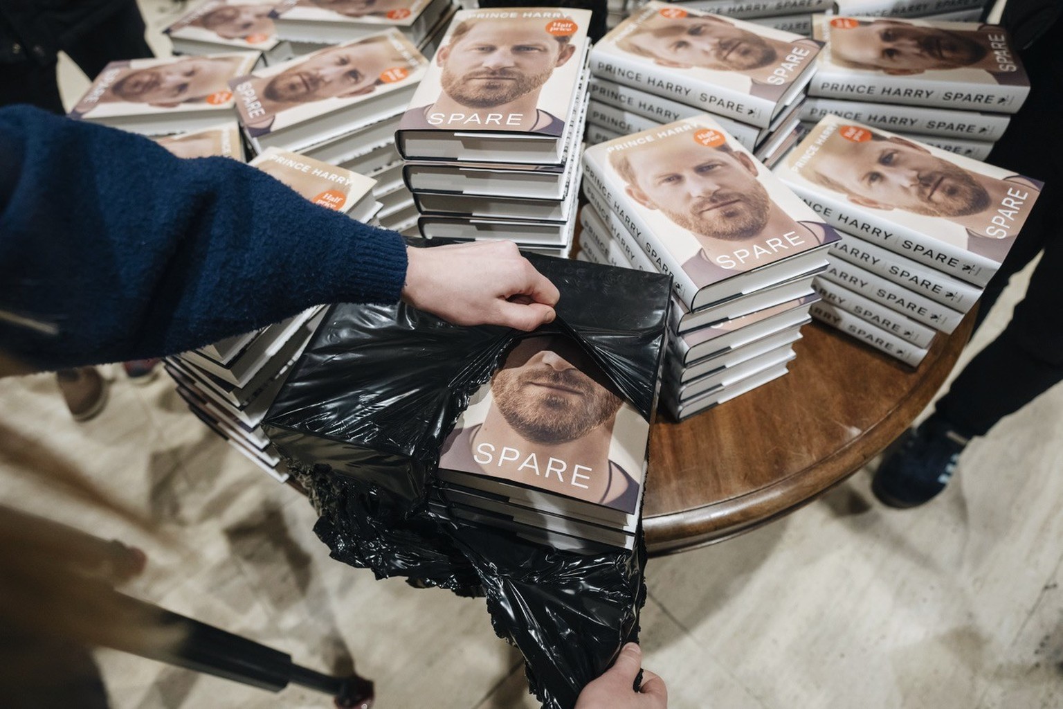 A member of staff places the copies of the new book by Prince Harry called &quot;Spare&quot; at a book store in London, Tuesday, Jan. 10, 2023. Prince Harry&#039;s memoir &quot;Spare&quot; went on sal ...