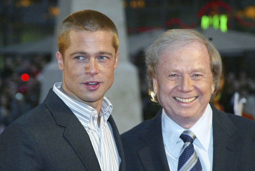 FILE - Actor Brad Pitt, left, and German director Wolfgang Petersen appear at the world premiere of the film "Troy" in Berlin, Germany, on May 9, 2004. Petersen, the German filmmaker whose W ...