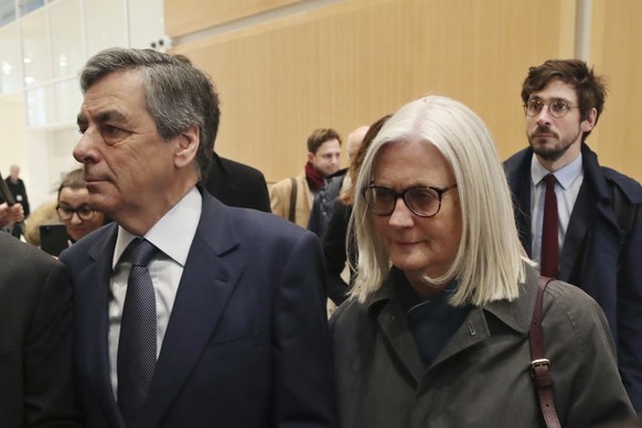 FILE - France&#039;s former Prime Minister Francois Fillon, left, and his wife Penelope, arrive at the Paris courthouse, in Paris, Wednesday, Feb. 26, 2020. (AP Photo/Thibault Camus, File)
France Le P ...