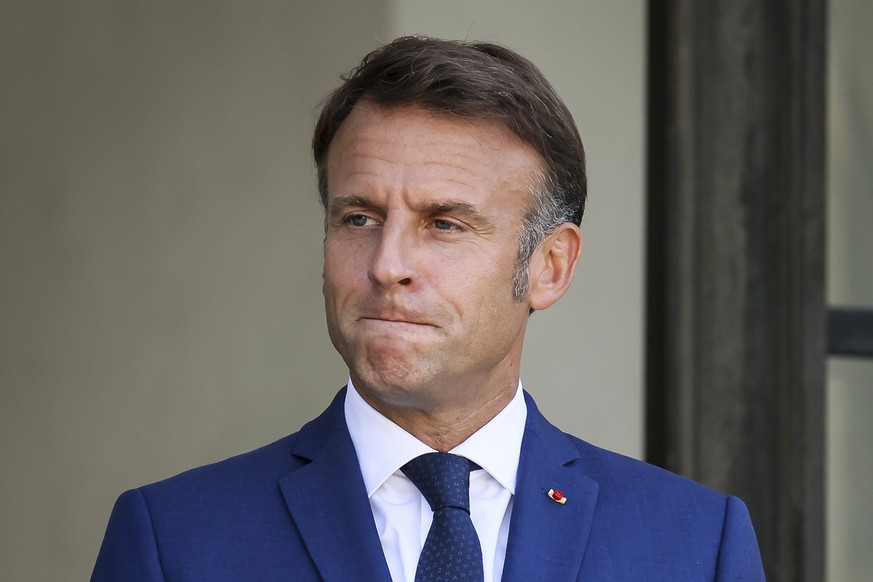 French President Emmanuel Macron gestures at the Elysee Palace as French left-wing coalition accuses Emmanuel Macron of denying democracy after he has rejected the New Popular Front&#039;s candidate t ...